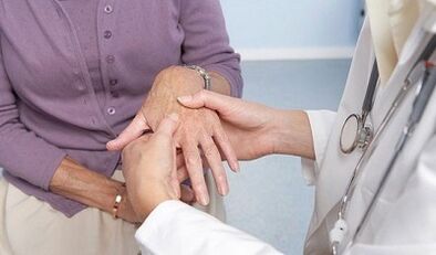 a doctor examines the joints of the hands in osteoarthritis and arthritis